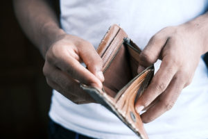 A man holds an empty wallet.