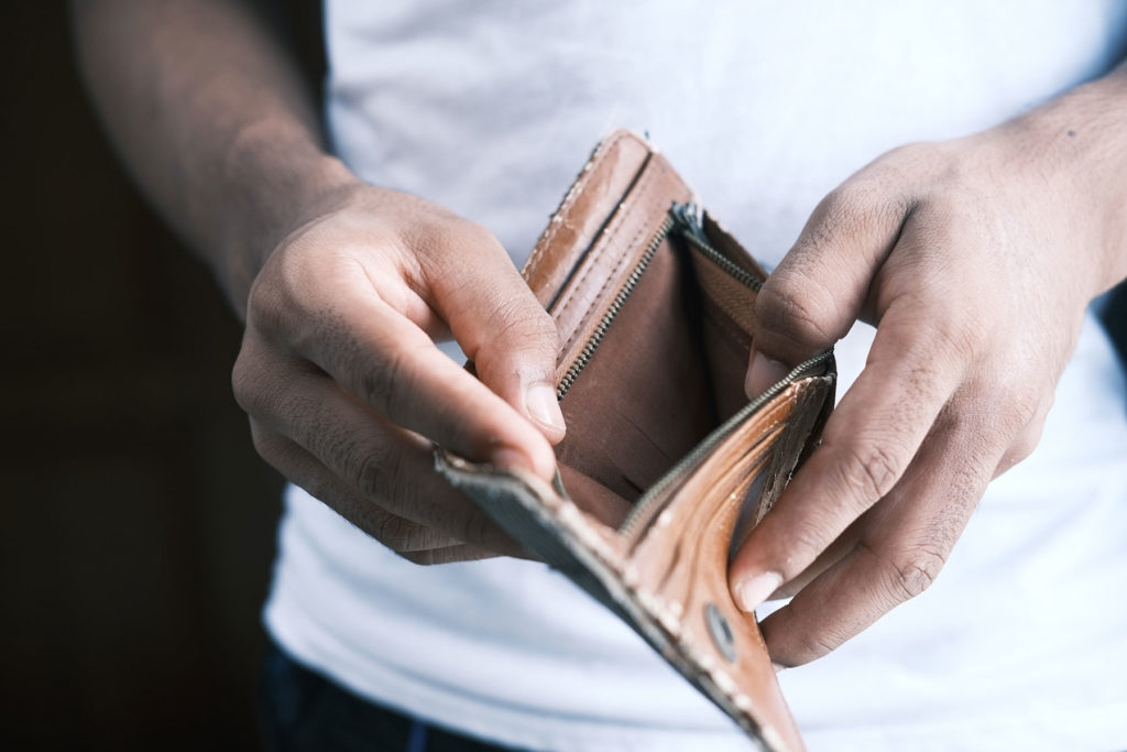 A man holds an empty wallet
