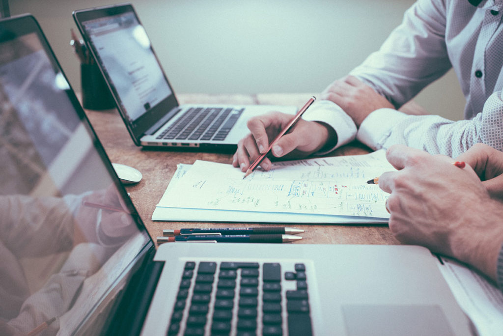 Two persons discussing a debt management plan.